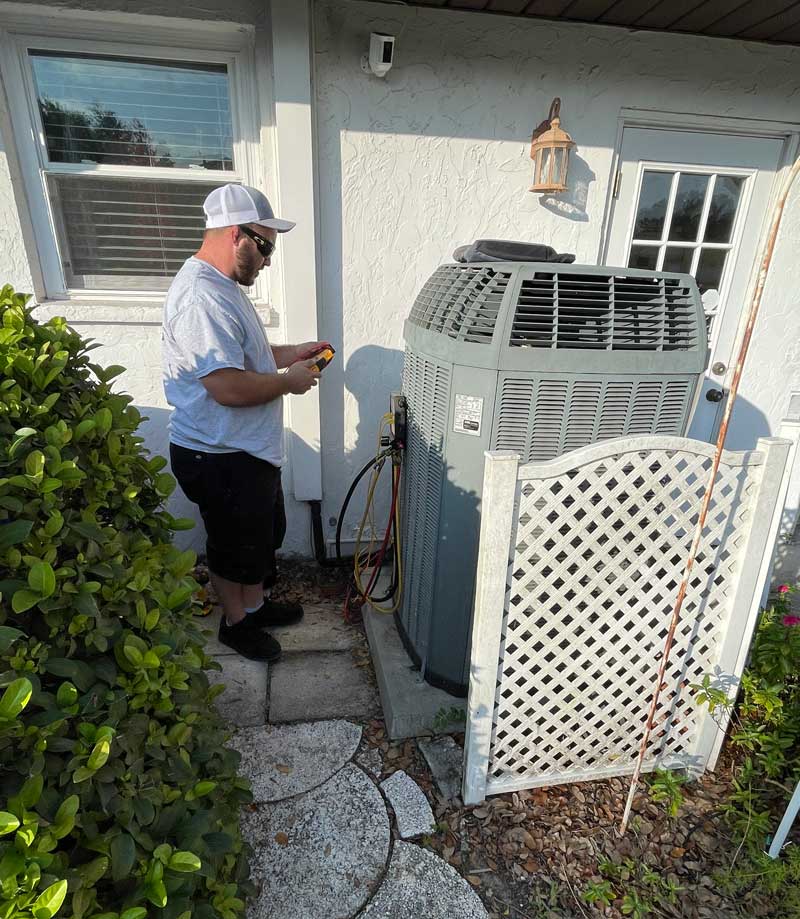 Technician performing heat pump repair