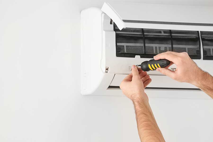 Technician performing AC leak repair