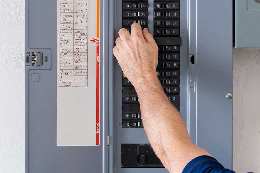 Electrician performing electrical panel repair and replacement