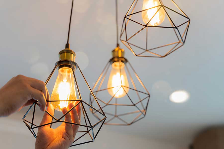 Electrician completing indoor lighting installation