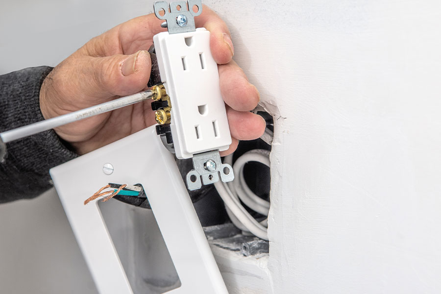 Electrical outlet installation service in progress