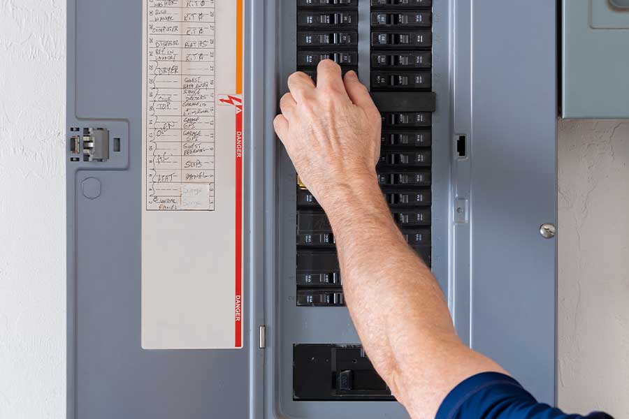 Emergency electrician repairing circuit breaker